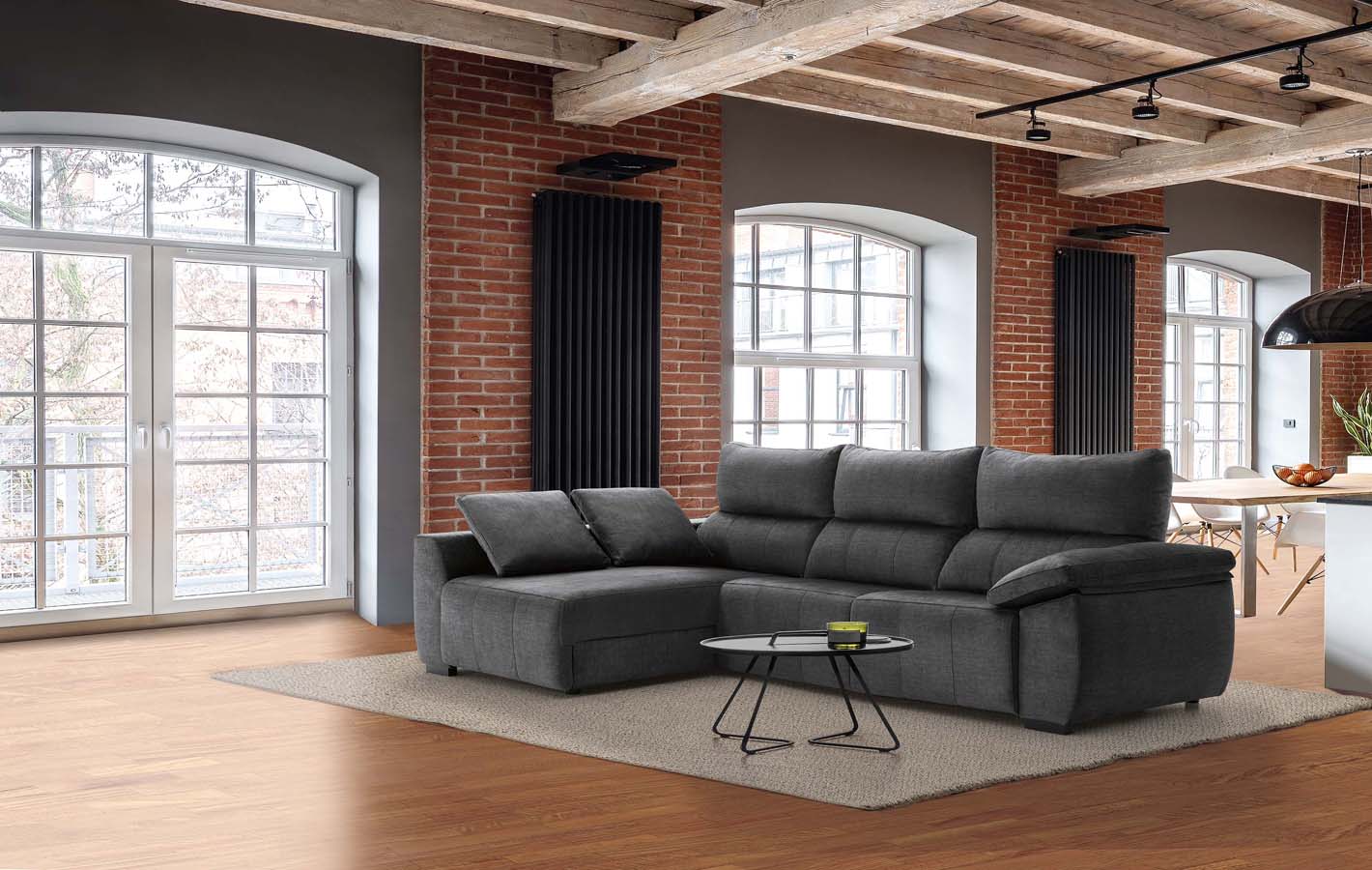 Industrial interior with gray corner sofa and big windows and brick wall